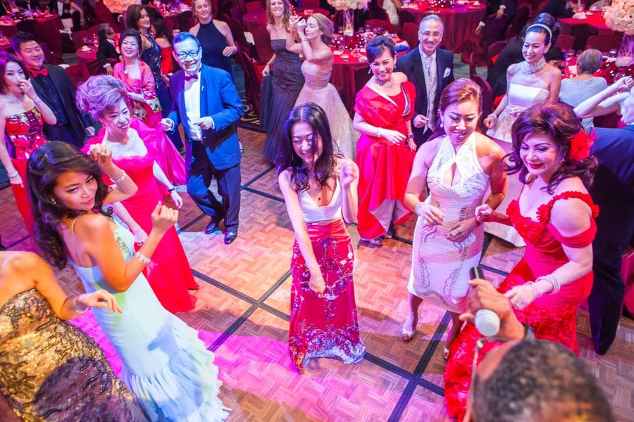 A group of people dancing at a formal event.